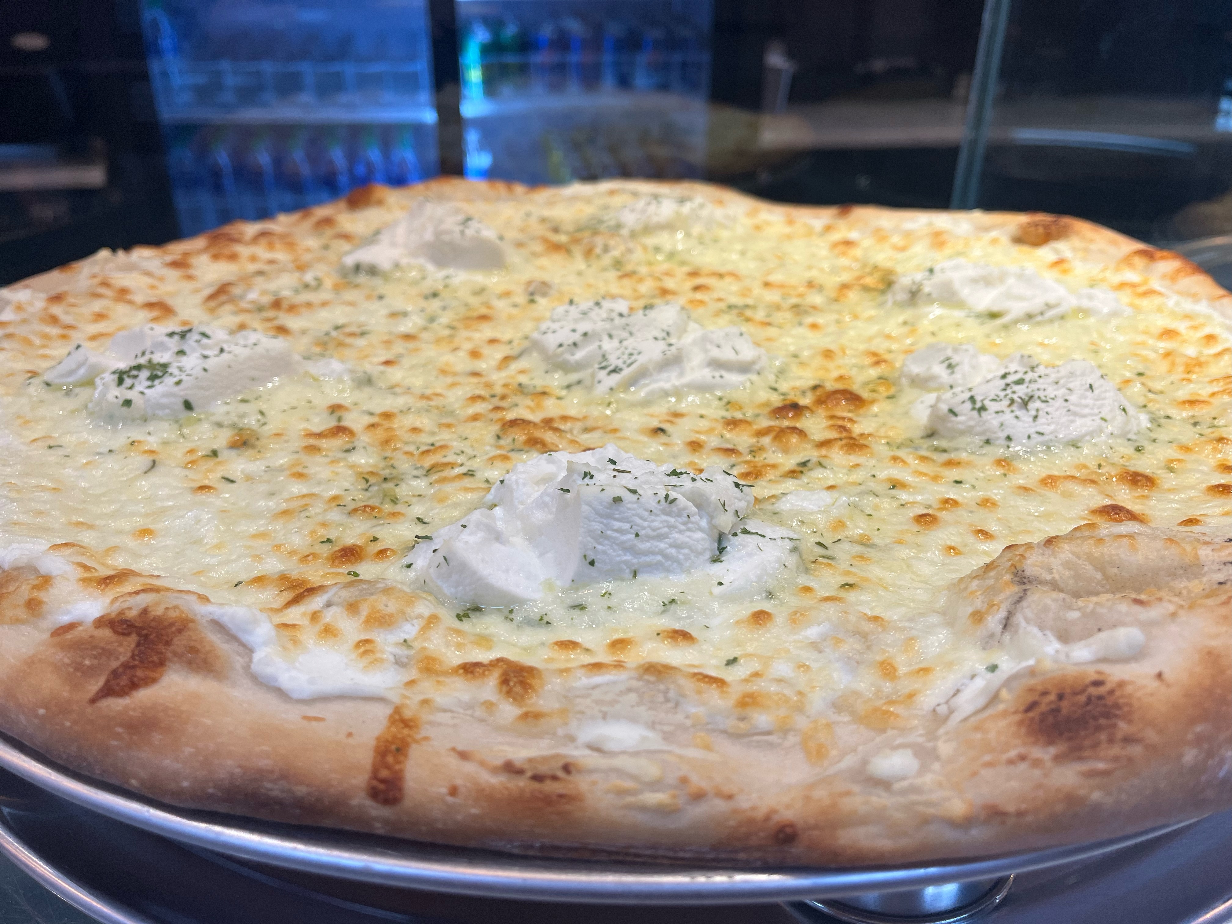 Image of delicious pizza with slice being taken out